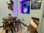 A tall table and three stools in the rec room - thumbnail