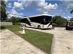 A motorcoach parked in a paved site - thumbnail