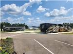 Two Class A motorhomes at sites - thumbnail