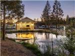 A building and pond at night - thumbnail