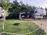 RV in a site with a fire ring - thumbnail