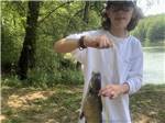 A boy holding a fish he caught - thumbnail