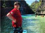 A man poses near the water - thumbnail