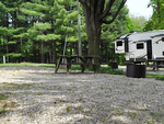 Gravel RV site with table and fire pit - thumbnail