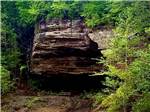 A picnic table near a scenic rock formation - thumbnail