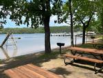 Picnic tables by the lake at Golden Acres Park - thumbnail