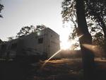 Sun setting behind an RV at Fireside RV Park - thumbnail