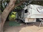 A fifth wheel in a shaded site - thumbnail