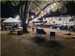 An RV site at night illuminated with patio lights - thumbnail