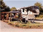 A RV site with fire pit and pergola - thumbnail