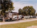 A row of RVs parked in their sites - thumbnail