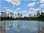 Blue sky and clouds reflecting on the pond - thumbnail