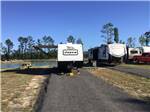 RVs parked in paved sites by the water - thumbnail
