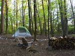A tent and stack of firewood at Skull Shoals Park & Campground - thumbnail