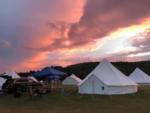 Sun setting over tents at site Adirondack Safari - thumbnail