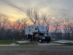 Camper parked with sun setting at Smoky Hill RV Park - thumbnail