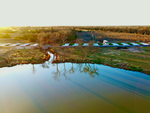 Aerial view of sites and pond at Ladera RV Resort - thumbnail