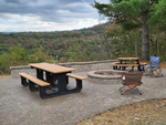 Table and firepit at site Wood Mountain Campground - thumbnail