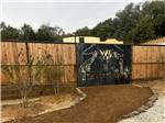 A dirt road leading to a gate - thumbnail