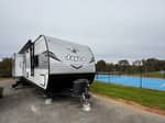 A travel trailer parked at a site - thumbnail