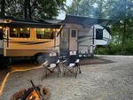 Parked trailer with fire pit at Camper Hollow RV Park and Campground - thumbnail