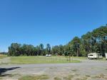 Parked trailer's next to open RV spaces at Buffalo Run RV Park - thumbnail