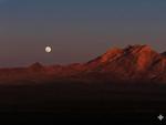 Full moon in sight as sun is setting at Tecopa Hot Springs Campground - thumbnail