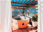 Outdoor hot tub under canopy - thumbnail