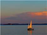 A sailboat on the ocean at dusk - thumbnail