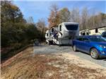 A blue car and fifth wheel parked at a site - thumbnail