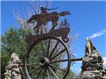 A metal sculpture on a wagon wheel - thumbnail