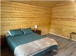 A queen bed in a rental cabin - thumbnail