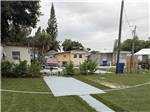 A paved RV site surrounded by grass - thumbnail