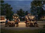 Group of people eating at a food truck - thumbnail