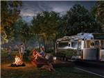 People sitting by a bonfire - thumbnail