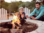 Kid and father around a fire pit - thumbnail