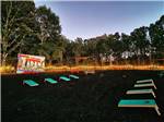 The cornhole area at dusk - thumbnail