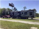 A fifth wheel trailer in an RV site at CAMPGROUNDS OF THE SOUTH - thumbnail