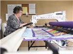 View larger image of Lady embroidering at VAL VISTA VILLAGE RV RESORT image #6
