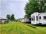 RVs parked on grassy sites at WESTGATE RV CAMPGROUND - thumbnail