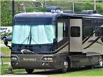 A motorhome in a gravel site at WESTGATE RV CAMPGROUND - thumbnail