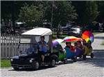 Kids being towed around by golf cart at BEYONDER GETAWAY AT RISING SUN - thumbnail