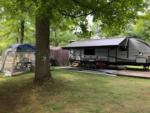 Parked trailer with covered patio at Twin Ells Campsite - thumbnail
