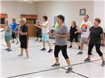 View larger image of A group of people exercising at TROPIC STAR RV RESORT image #8