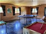 Ping pong table and other table games in the rec room at CAMPING CABANO, ENR.205310 - thumbnail