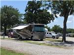 A motorhome in a gravel RV site at LAZY L RV PARK - thumbnail