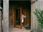 A woman walking into a sauna - thumbnail