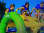 Kids climbing the Wibit floats at CAMPING PARADIS DE LA P'TITE MONTAGNE - thumbnail