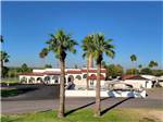 View larger image of A pair of palm trees in front of the office at CHIMNEY PARK RESORT image #1