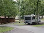 A trailer parked in a RV site next to the laundry room at FORT WILDERNESS CAMPGROUND AND RV PARK - thumbnail